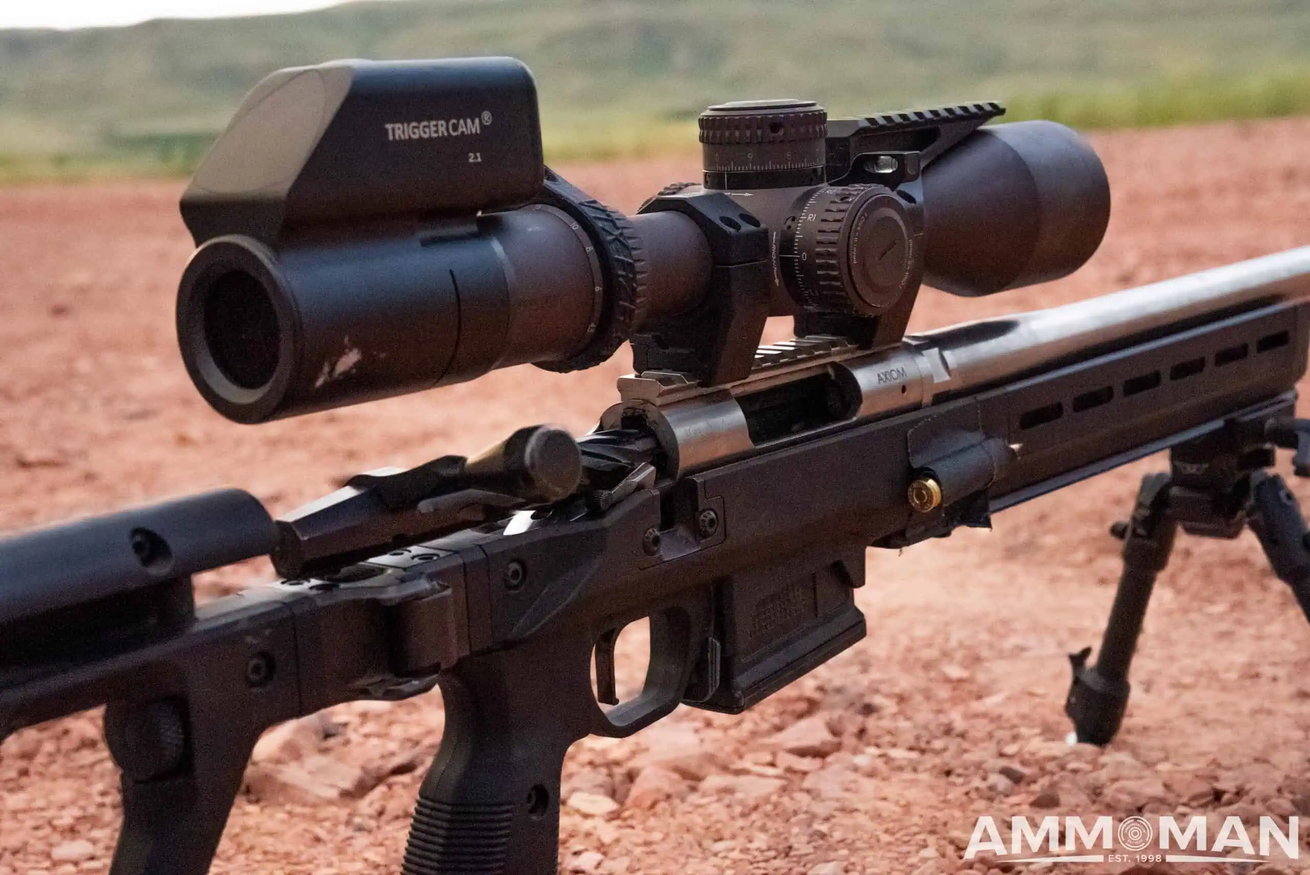 Precision rifle sitting on dirt