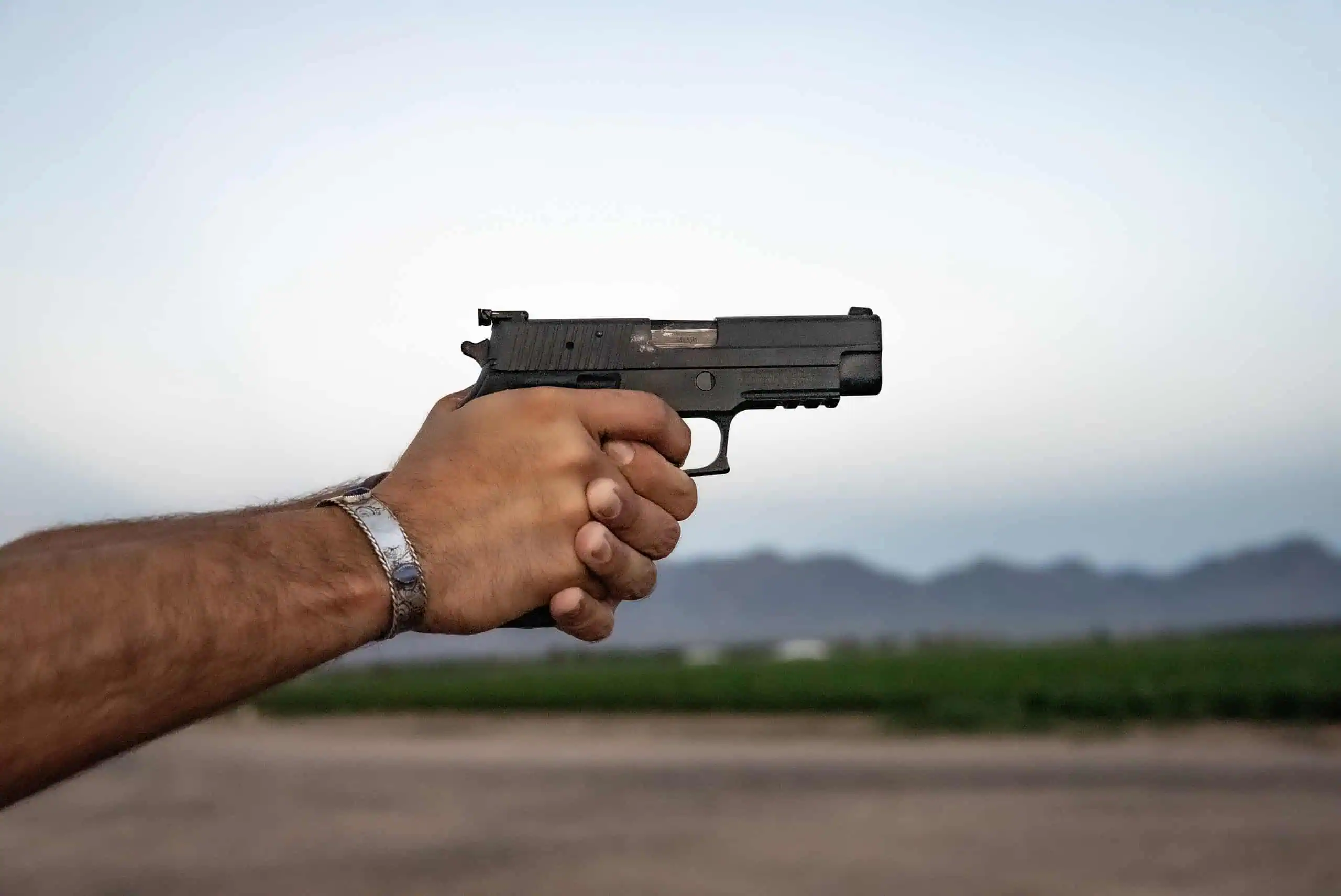 Shooting a pistol with proper grip.