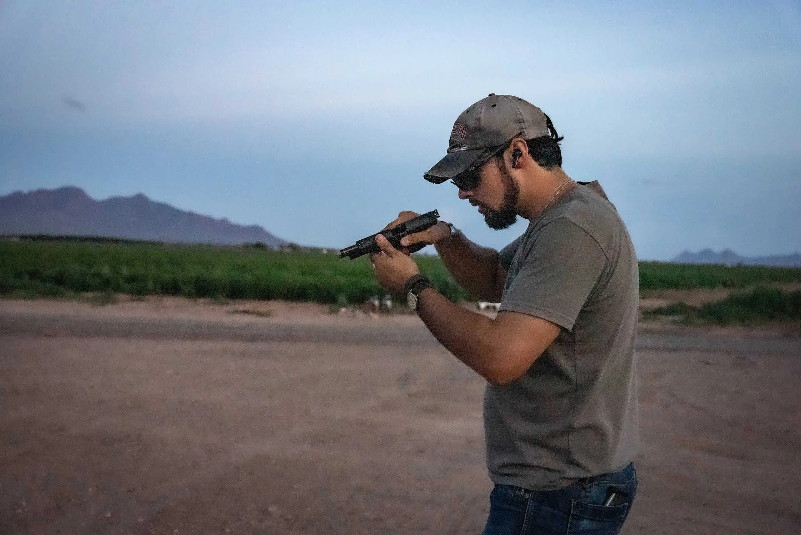 Inspecting pistol after a malfunction.