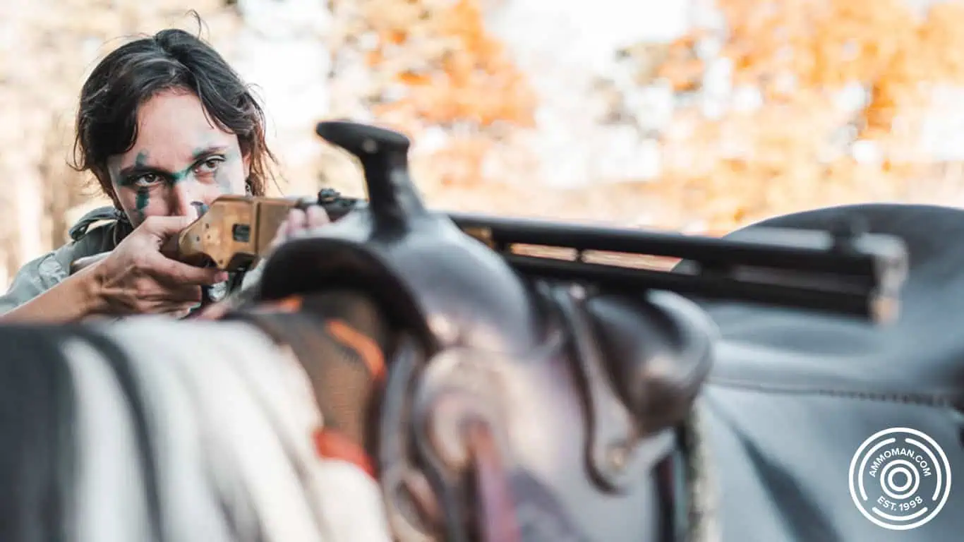 Girl shooting lever action 30-30 from horse.