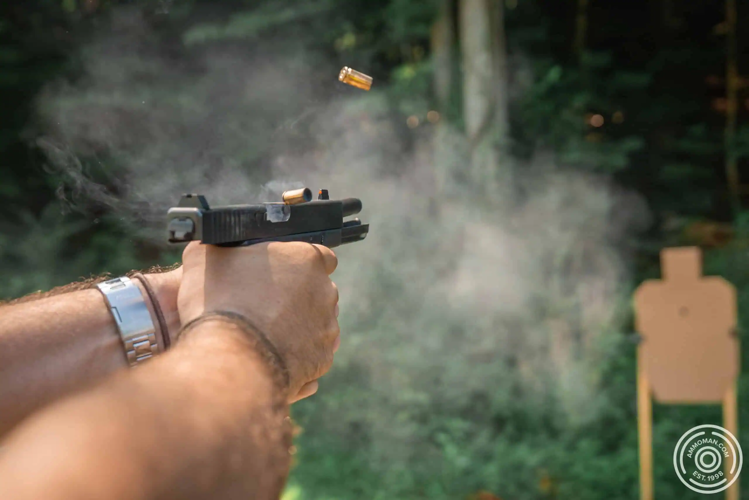 Shooting a "doubles" pistol drill on a USPSA target.