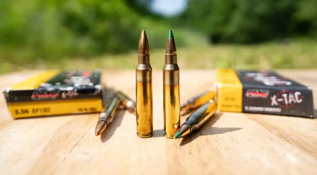 PMC 5.56 55 grain ammo next to 62 grain ammo at a shooting range