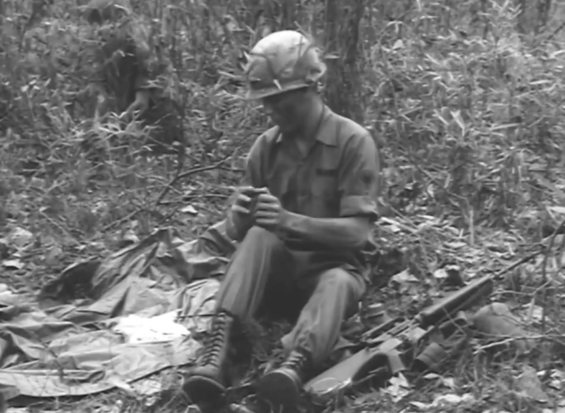 Soldier preparing to clean his M16 in a training film.