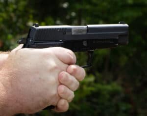 The author pulling the trigger on a Hammer-fired Colt 1911