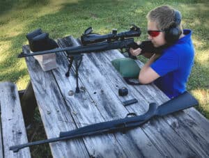 A young shooter firing his first rifle at the range.