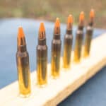 red tipped 5.56 ammo lined up at a shooting range