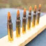 red tipped 5.56 ammo lined up at a shooting range