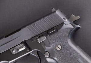 SA/DA Hammer fired SIG SAUER pistol on a black background