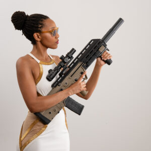 A model posing with a 300 BLK Kriss rifle.