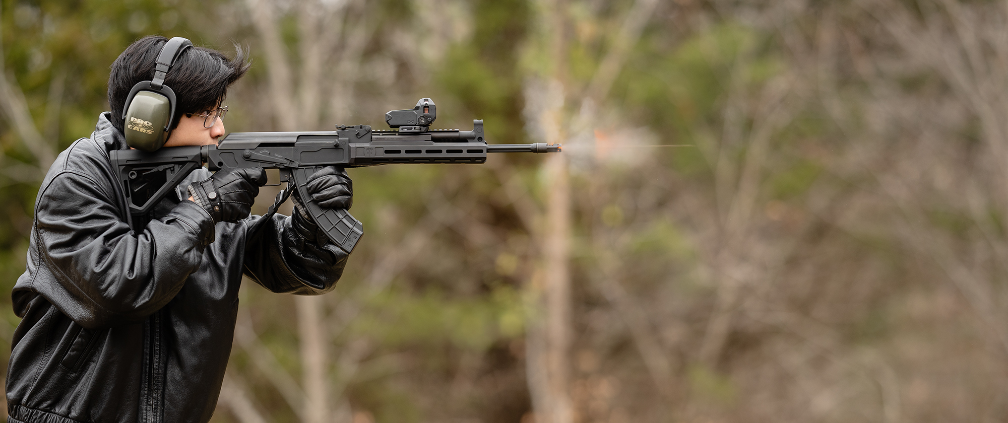 Firing light-mounted AK-47 A rifleman firing an AK-47 with a meprolight at a shooting range